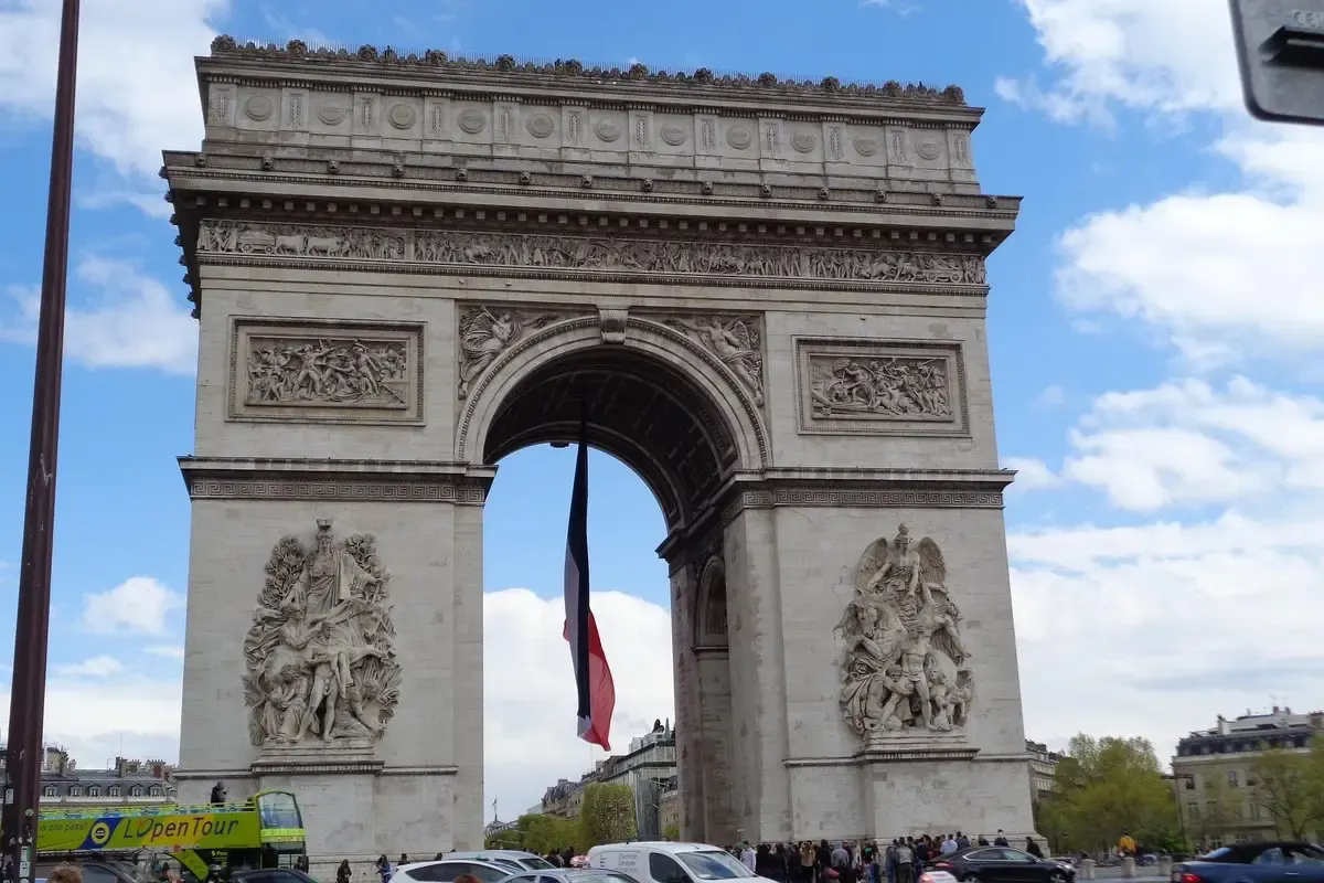 De Arc de Triomphe met wapperende Franse vlag onder de boog